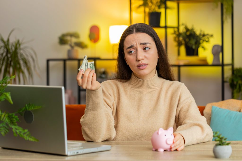 OZEV Grant Eligibility: Who’s Eligible and How to Apply in the UK 5 poor caucasian young woman holding piggybank one dollar insufficient amount money poverty